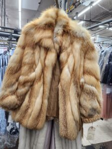 fur coat on hanger at dry cleaner