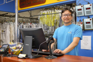 store owner smiling at work