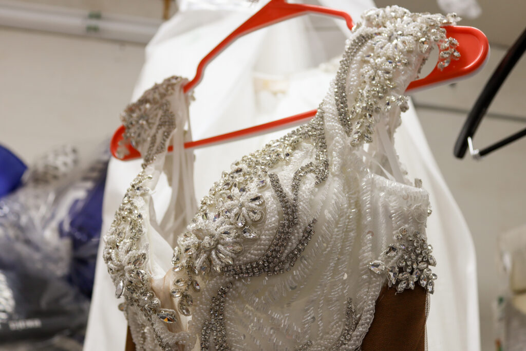 Beaded wedding dress on clothing hanger