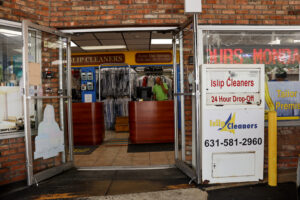 man on phone inside dry cleaning store