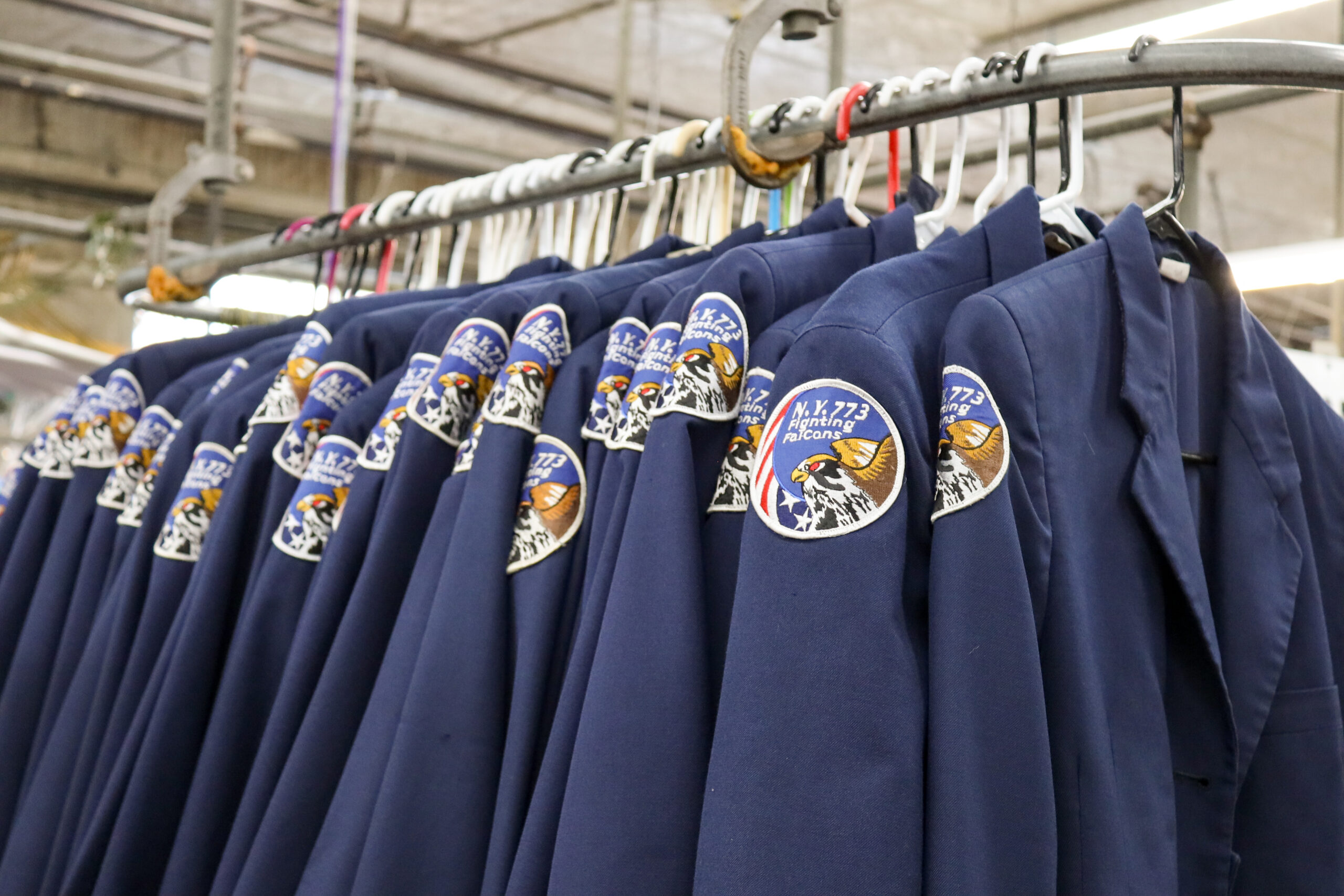 Uniforms on garment conveyor at dry cleaners