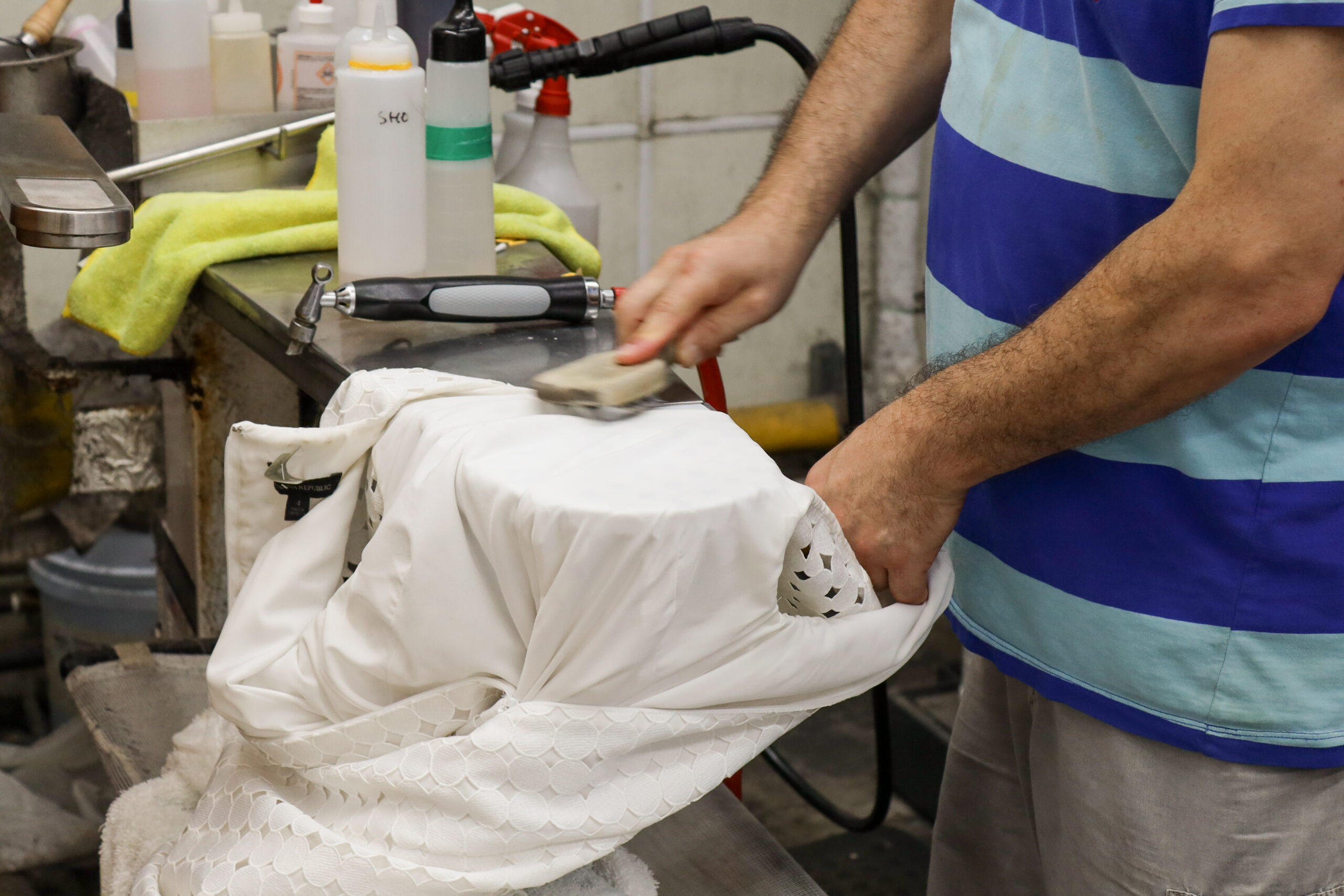 Man cleaning shirt with brush