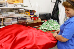 Tailor measuring red dress